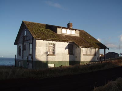Photo of white cottage.